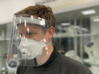 Ricoh employee wearing 3D printed protective covid face shield