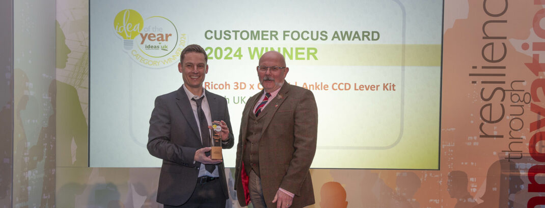 Ricoh 3D's Senior Engineer and Medical Lead, Richard Minifie collecting the IdeasUK 'Customer Focus' award.